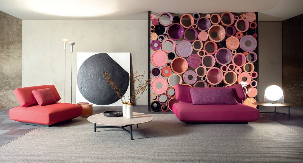 Agio Modular sofa composed of large platforms, backrest can be adjusted, all upholstered in red fabric in a living room.