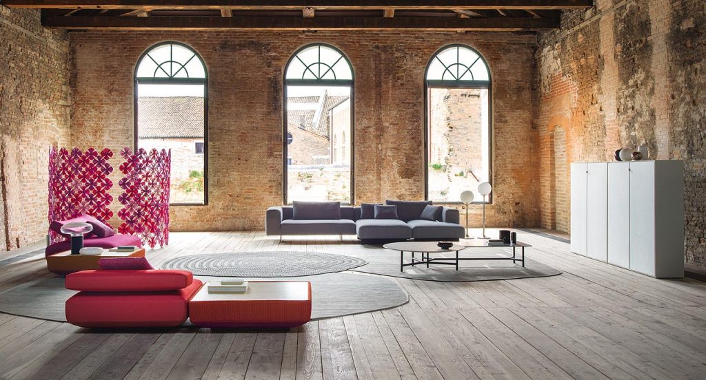 Agio Modular sofa composed of large platforms, backrest can be adjusted, all upholstered in red fabric in a living room.