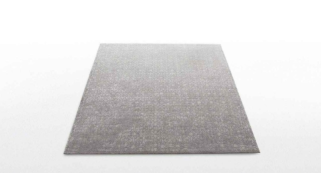 Brown Alkazar rug with geometric pattern made of wool on awhite background.