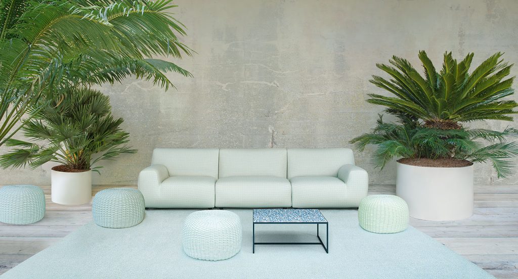 Cocci side table, black steel frame, blue and white square ceramic top in a living room.