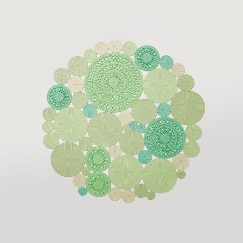 Cosmo rug, made of green and white round modules on a white background.