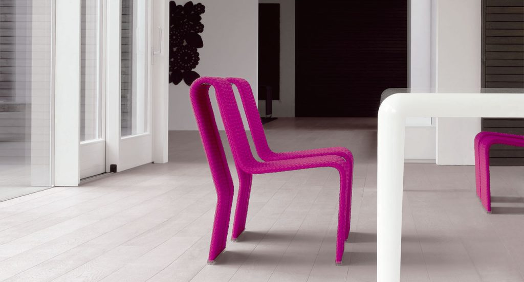 Two Frame Chairs, upholstery in purple rope braids in a dining room.