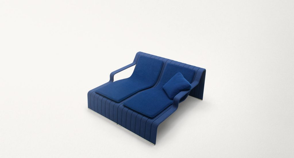 Two blue Frame Chaises, upholstey of rope braids, seat pad and cushion on a white background.