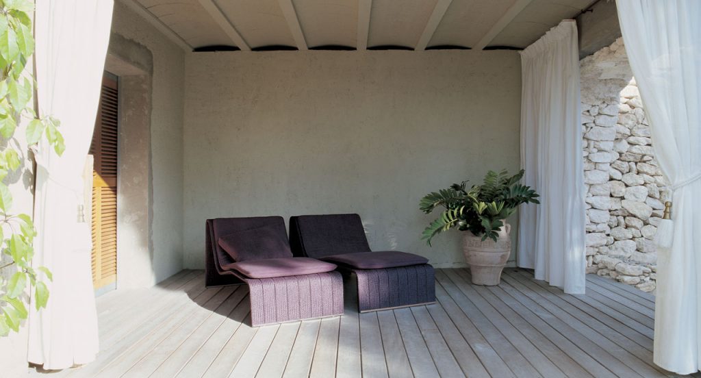 Two purple Frame Chaises, upholstey of rope braids, seat pad and cushion in a terrace.