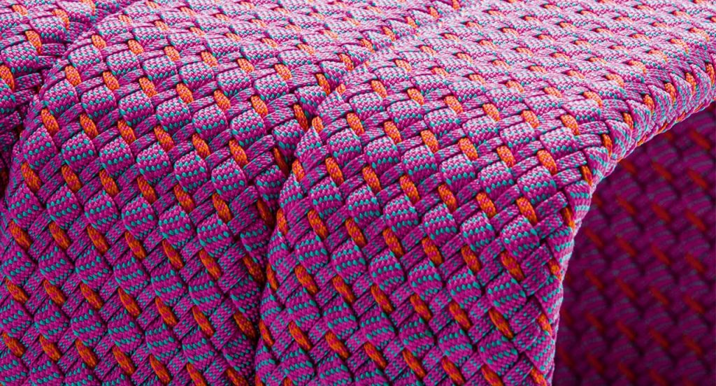 Square Frame Coffee Table, upholstery in purple and red rope braids.