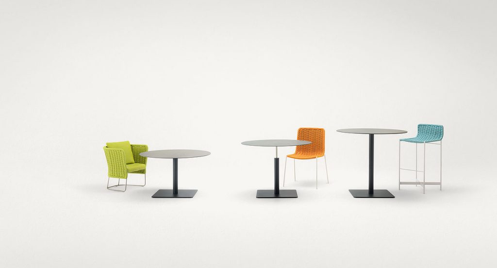Three black Giro Outdoor Table tables, structure and central leg in steel, top in concrete on a white background.