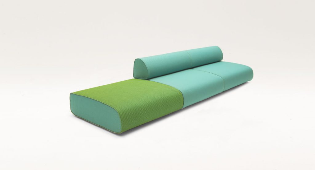 Three Ola Poufs, two with backrest. Upholstery in green and blue fabric on a white background.