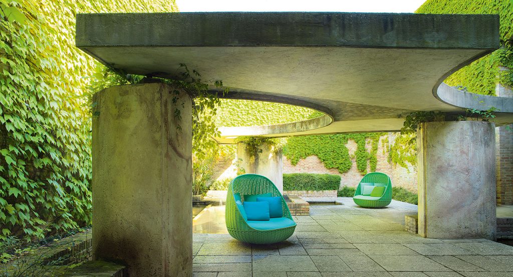 Two Orbitry Armchairs structural weave of flat braid in green Rope yarn with cushion in a garden