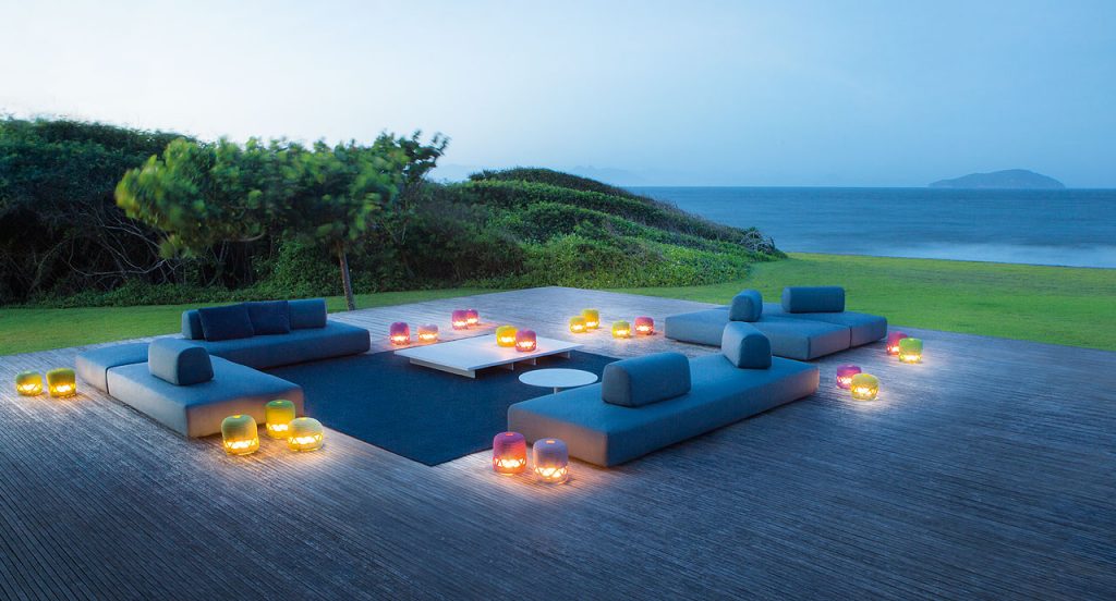 Four Orlando Outdoor Sectionals with backrest, upholstered in blue fabric in a terrace.