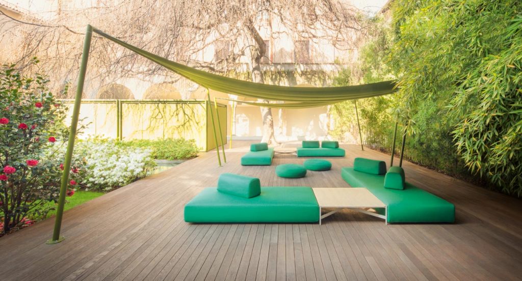 Four Orlando Outdoor Sectionals with backrest, upholstered in green fabric in a terrace.