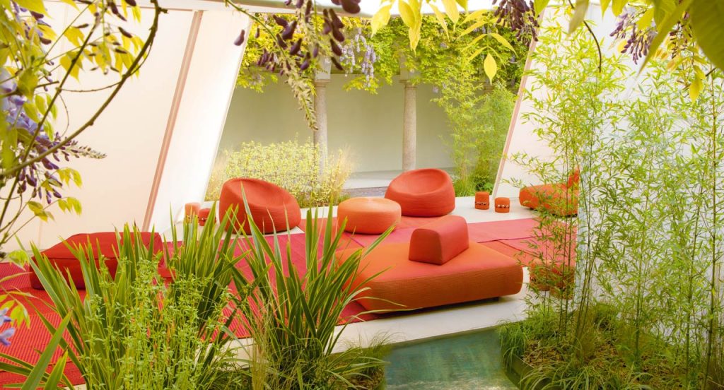 Three Otto Armchairs, upholstery in red rope cord in a terrace.