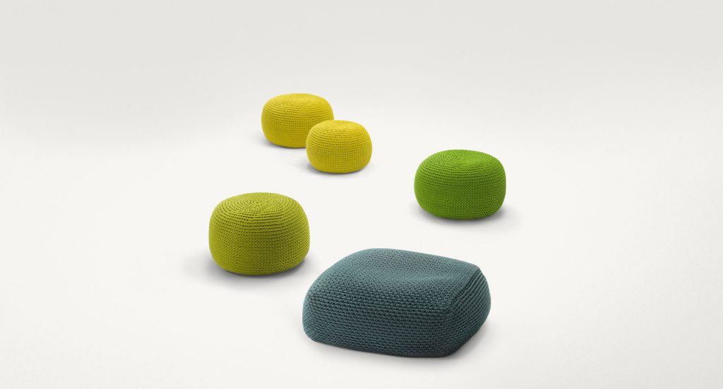 Five Picot Outdoor Poufs made of cordon rope, two in yellow, two in green and one in blue. Four in round and one in square shape on a white background.