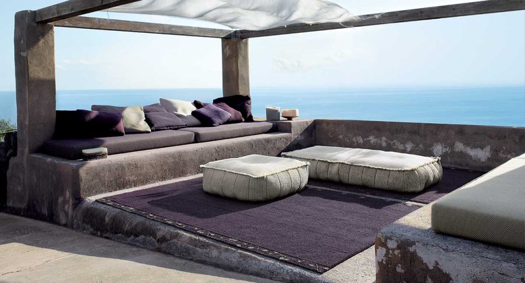 Two Play poufs in white fabric upholstery, square shape in a terrace.