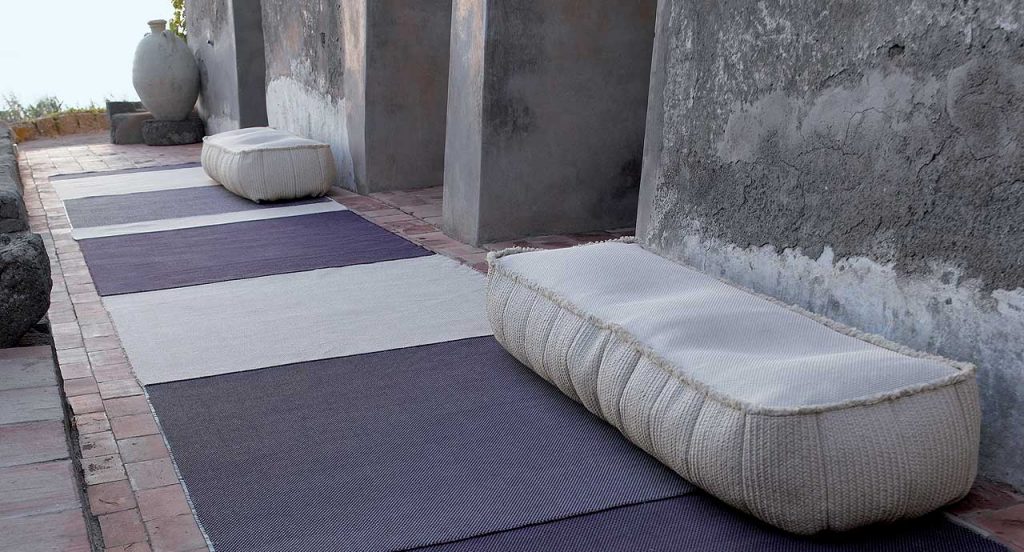 Two Play poufs in white fabric upholstery, rectangular shape in a terrace.