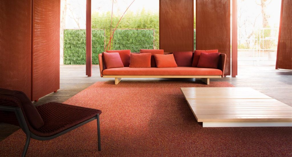 Red Policromo-Policromo Double rug in a living room.