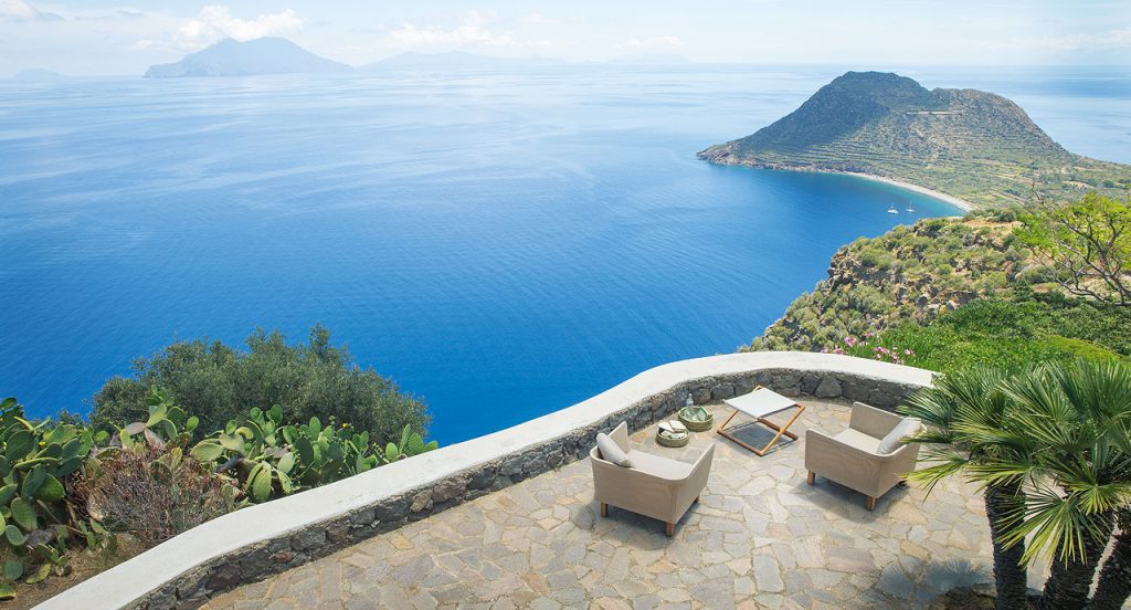 Portofino Outdoor Stool, structure in natural heartwood. Top in white steel in a terrace.