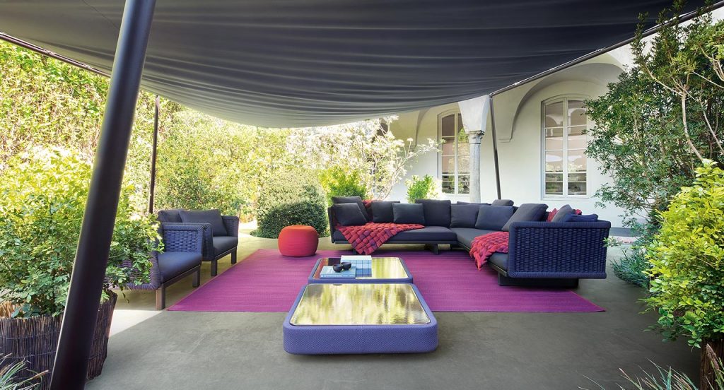 Ray rug made with black and purple wide braids in a living room.