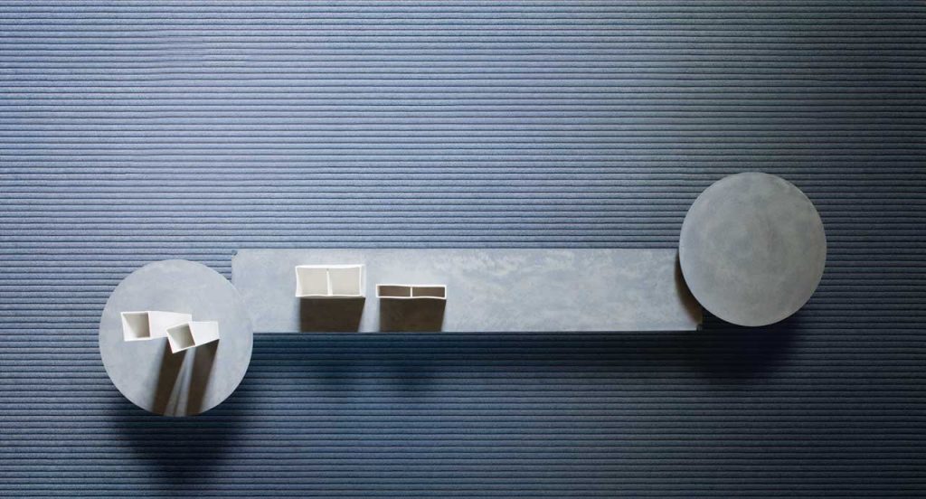 Samo rug made of grey rope cords and irregular shape under a table.