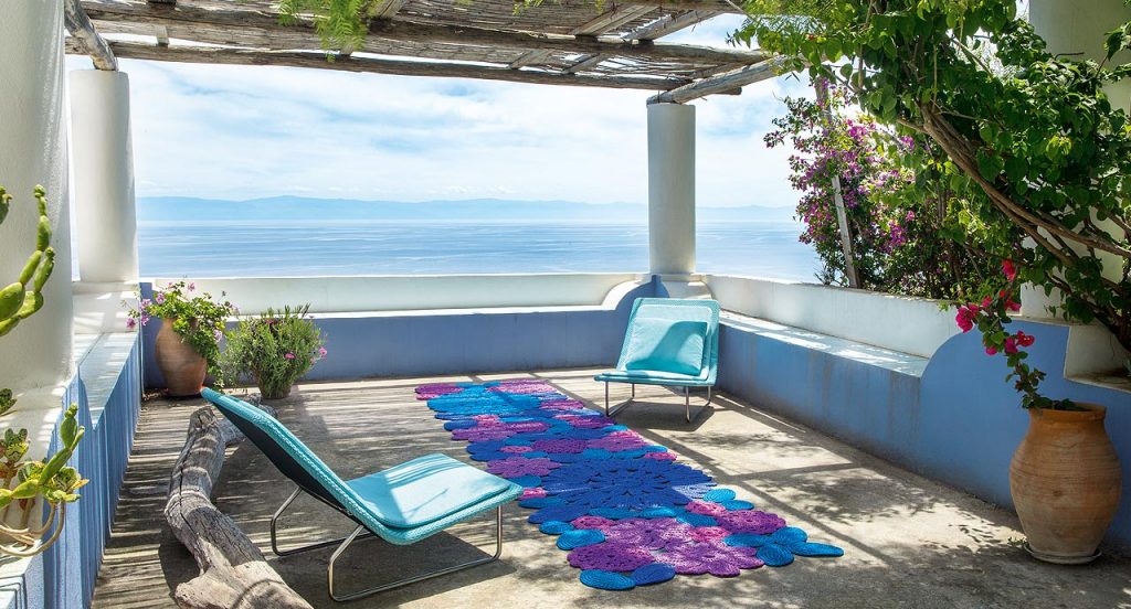 Two blue Sand lounge chair with backrest, structure in steel , upholstery in rope fabric, cushion in polyester in the terrace.