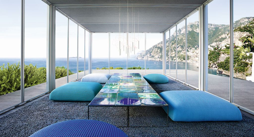 Sciara Side Table, structure in black steel, top in lava stone in blue in a living room.