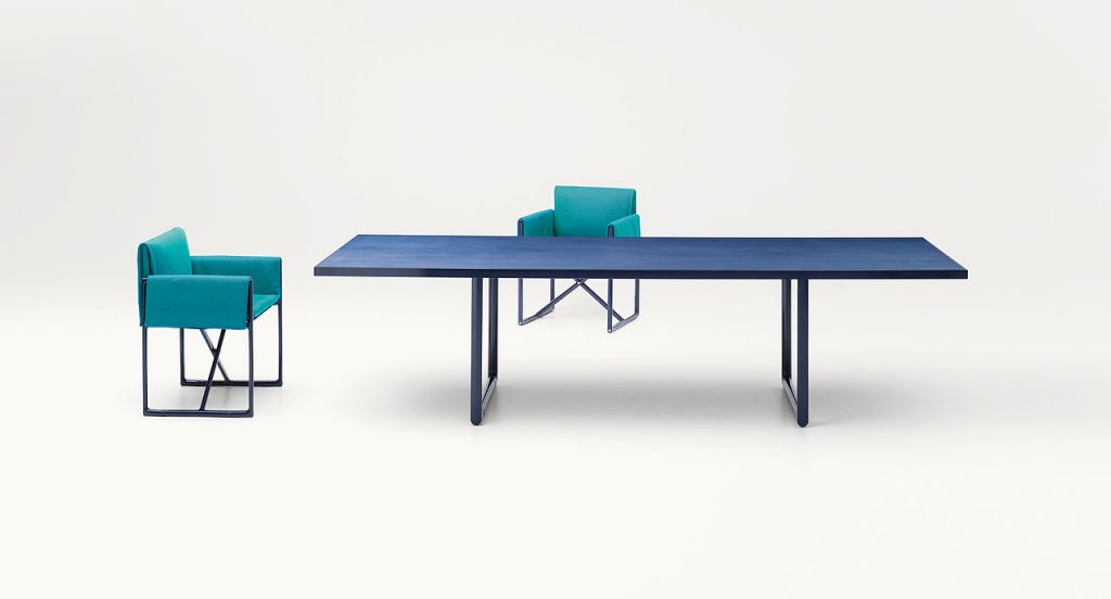 Portofino Indoor Dining Table, Structure and two legs in black steel, top in blue fibreboard in a dining room.