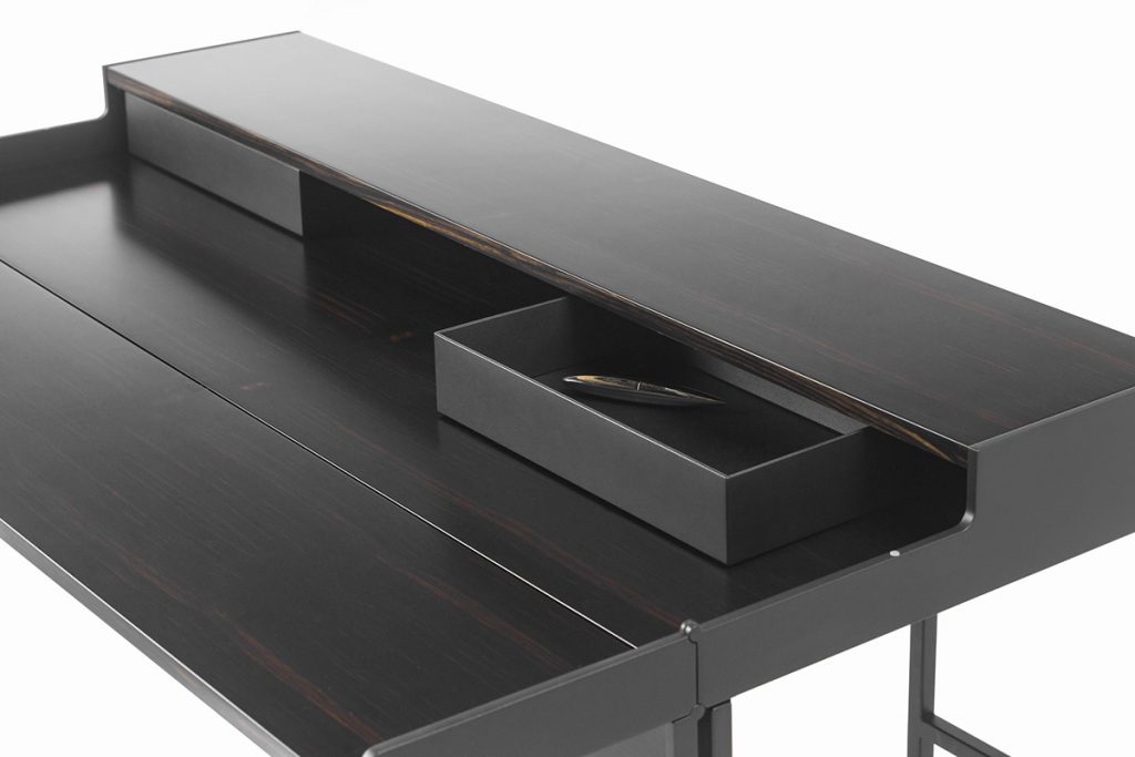desktop finishes in shiny steel and black wood on a white background