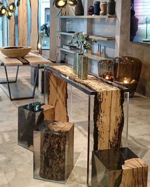 Three Anchor Stool/Side Tables with a cubic shape, made of solid wood and transparent resin inlays, in a showroom.