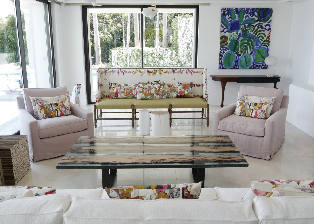 Chimenti Coffee Table with an elongated, rectangular shape, made of solid wood with a natural finish and featuring a transparent resin inlay in a living room.