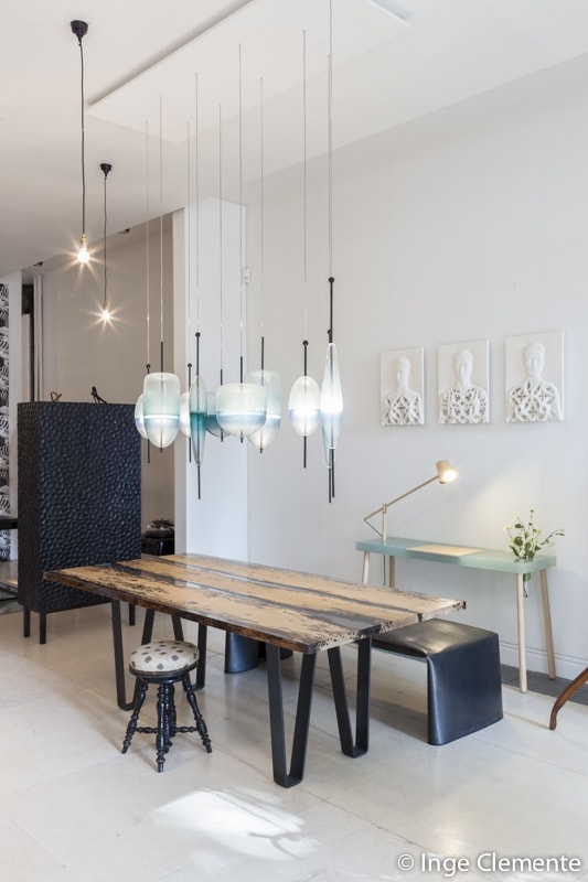 Chimenti Table with an elongated, organic shape, made of solid wood with a natural finish and featuring a transparent resin inlay, in a living room.