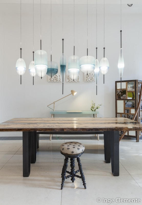 Chimenti Table with an elongated, organic shape, made of solid wood with a natural finish and featuring a transparent resin inlay, in a living room.