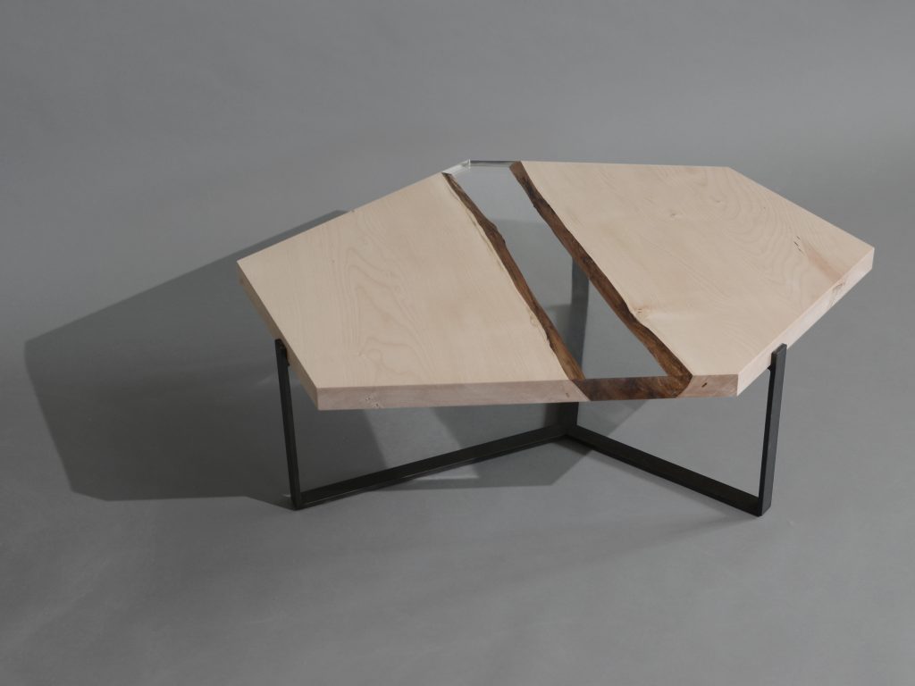 Crystal Maple Low Table with a polygonal shape, made of solid maple wood with a natural finish and featuring a transparent resin inlay, set against a white background.