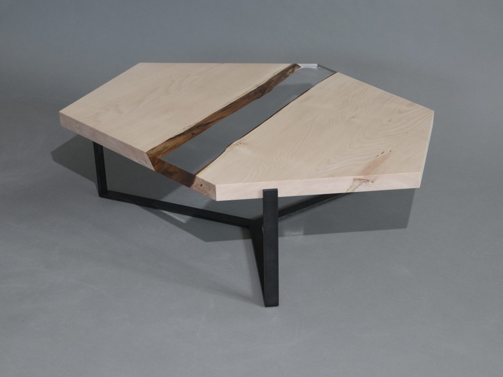Crystal Maple Low Table with a polygonal shape, made of solid maple wood with a natural finish and featuring a transparent resin inlay, set against a white background.