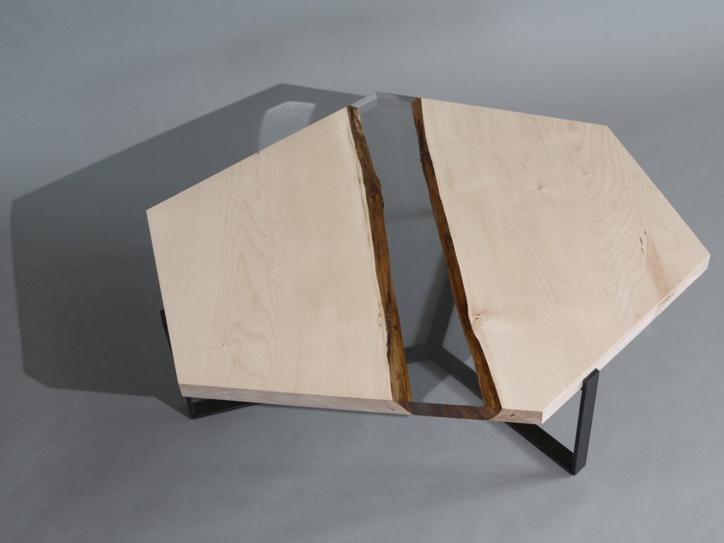 Crystal Maple Low Table with a polygonal shape, made of solid maple wood with a natural finish and featuring a transparent resin inlay, set against a white background.