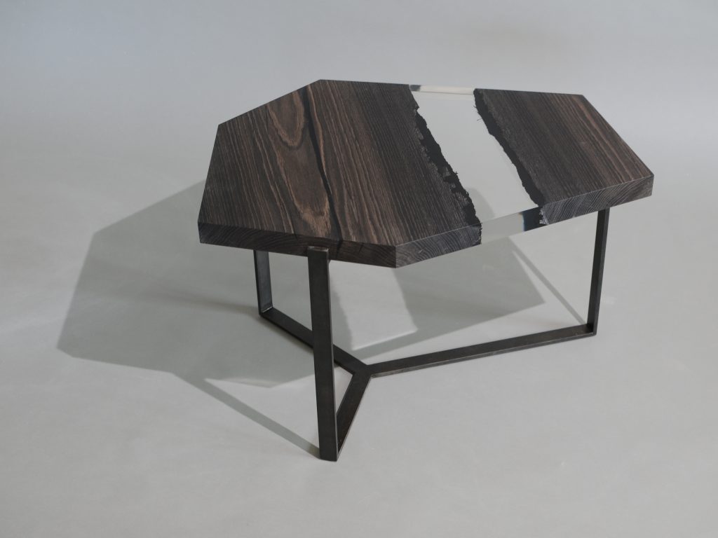 Crystal Peatwood Low Table with an polygonal shape, made of solid peatwood with a natural finish and featuring a transparent resin inlay, set against a white background.
