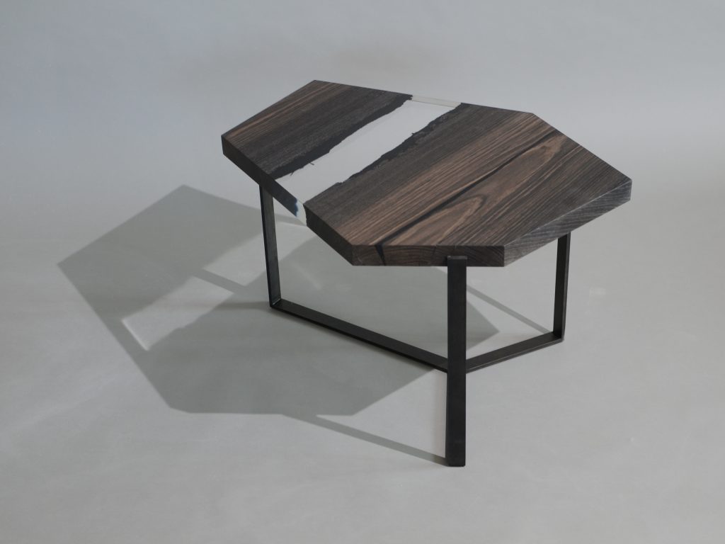 Crystal Peatwood Low Table with an polygonal shape, made of solid peatwood with a natural finish and featuring a transparent resin inlay, set against a white background.