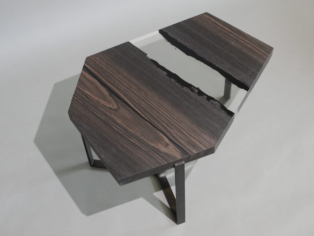 Crystal Peatwood Low Table with an polygonal shape, made of solid peatwood with a natural finish and featuring a transparent resin inlay, set against a white background.