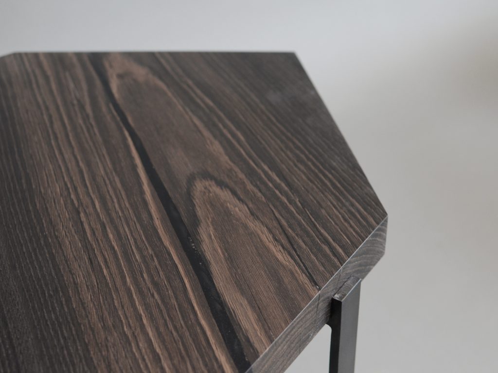 Closeup of Crystal Peatwood Low Table with an polygonal shape, made of solid peatwood with a natural finish and featuring a transparent resin inlay, set against a white background.