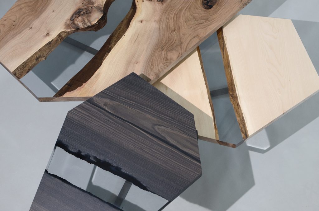Crystal Wood Trio Low Tables featuring three tables with polygonal shapes, made of solid wood with natural finishes and transparent resin inlays, on a white background.