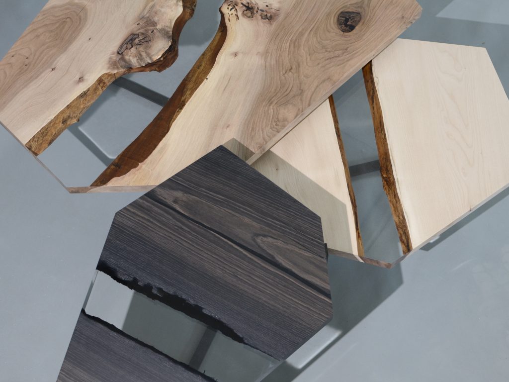 Crystal Wood Trio Low Tables featuring three tables with polygonal shapes, made of solid wood with natural finishes and transparent resin inlays, on a white background.