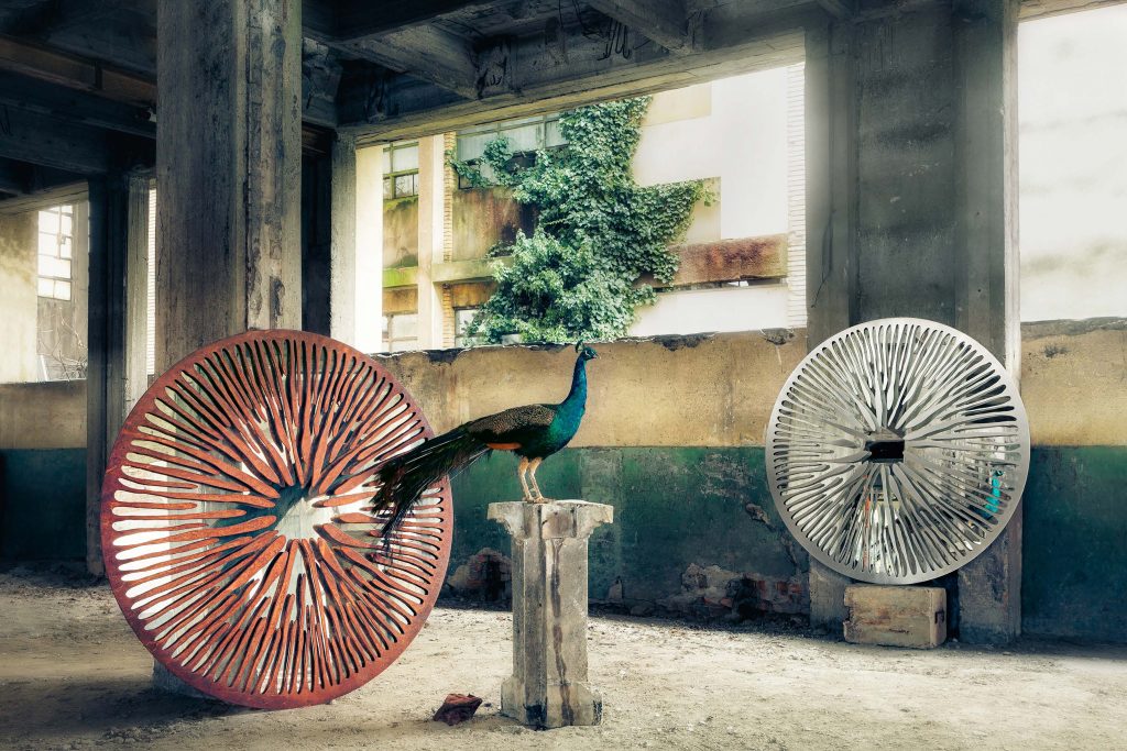 two mirrors in the shape of a sculptural circle made of various materials in shades of red and white