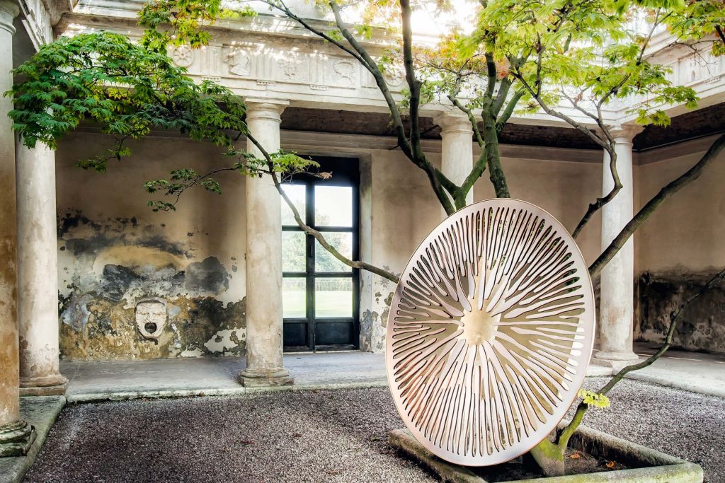 sculptural circular mirror made from natural materials in a white tone