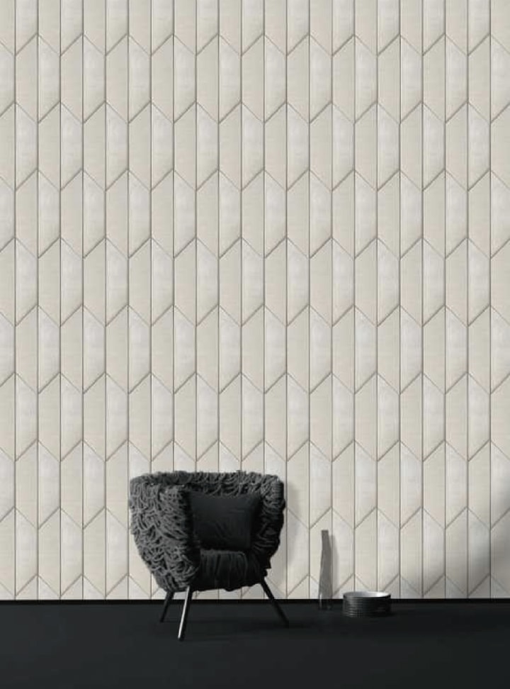 Decadence3D mosaic with polygonal geometric patterns in shades of white, on a wall.