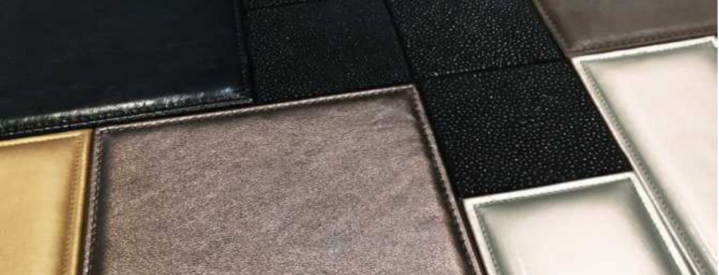 Maxime mosaic in brown, black, gray and yellow with rectangular patterns on a wall.