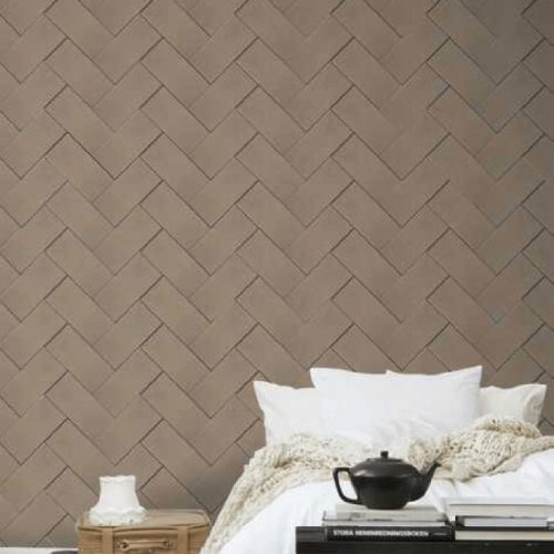 Papillon mosaic in with rectangular patterns, set against a wall.