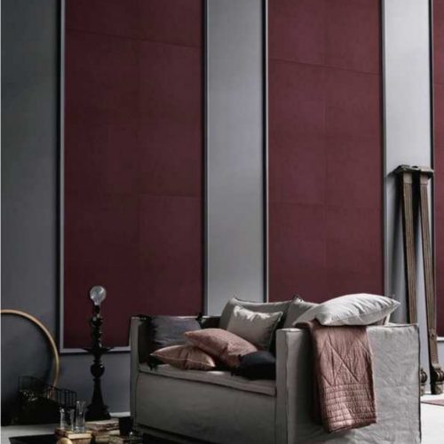 Pure Mosaic in purple with rectangular patterns on a wall.