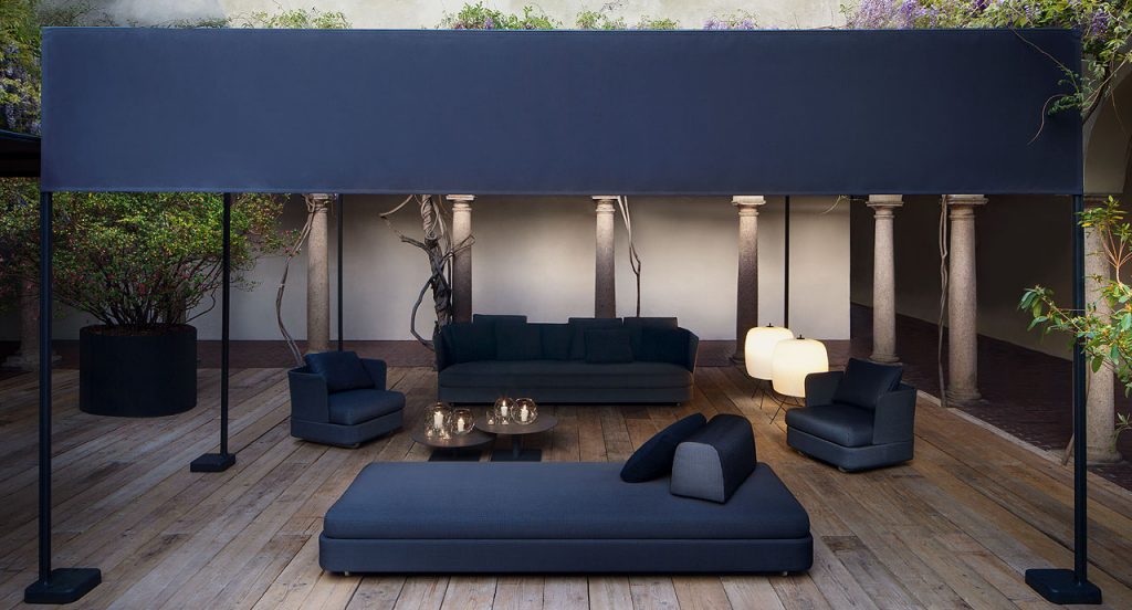 Two Shoji floor lamps, cover in semi transparent polyester cord and three black steel legs in a living room.