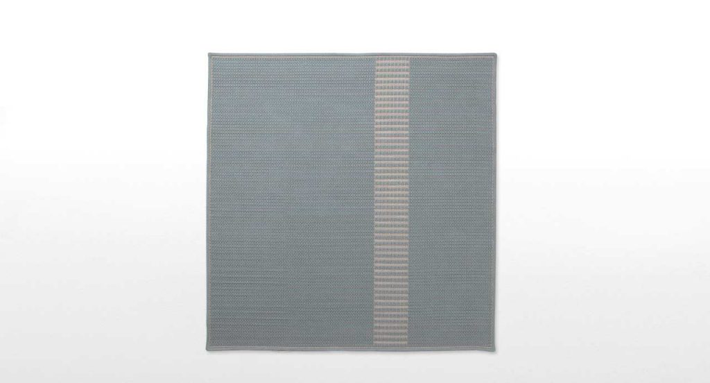 Siepe rug, embroidery made of flat braid in kimia blue and brown fabric on a white background.