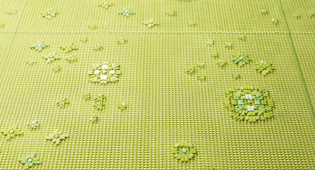 Spring Modular Rug with embroidered floral pattern in green.