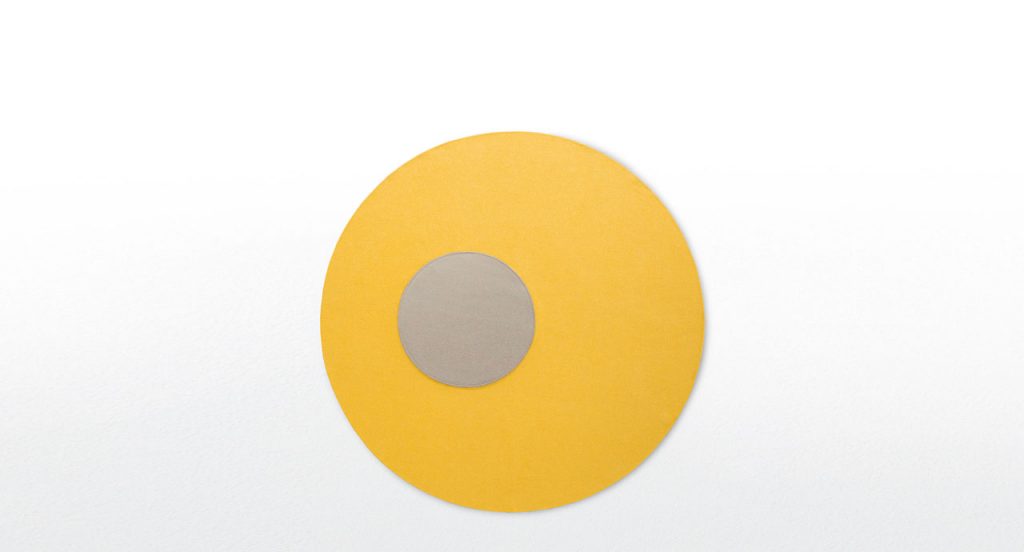 Round Tondo rug in yellow with a brown central circle on a white background.