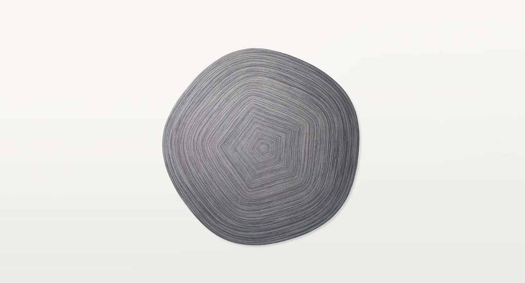 Grey Zoe Natural rug wool cord in a pentagonal form on a white background.